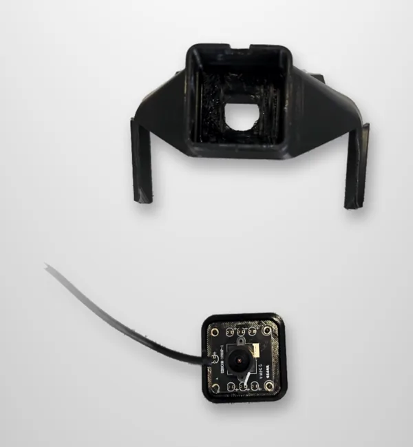 The hood top with its square camera opening, the front cover, and the USB camera board with its lens