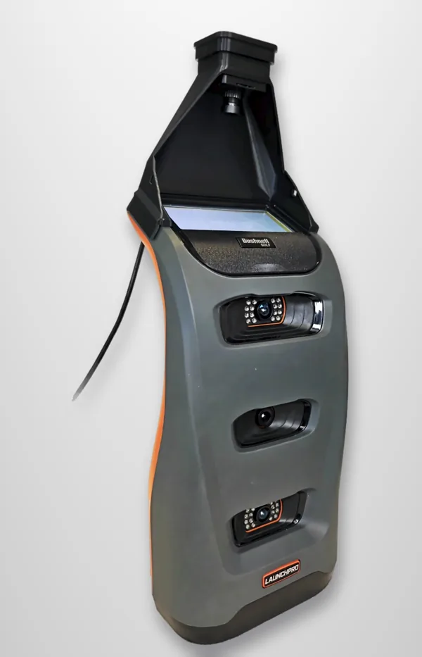 A black 3D-printed FreeDrop camera hood fitted on a grey Bushnell Launch Pro, USB cable running down the side